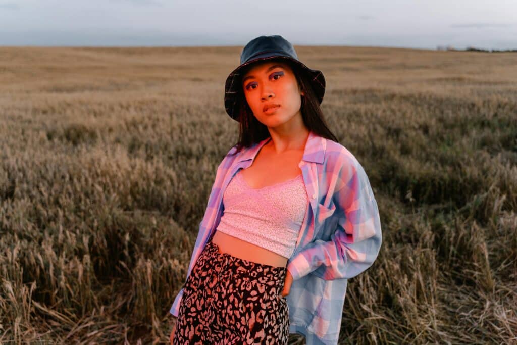 Vrouw in een grasveld met een rode gloed over haar heen